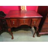A Georgian revival oak low boy the three frieze drawers over pad foot cabriole legs, 71cm high x