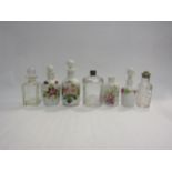 Four ceramic scent bottles with floral design, one missing stopper and three glass jars (7)