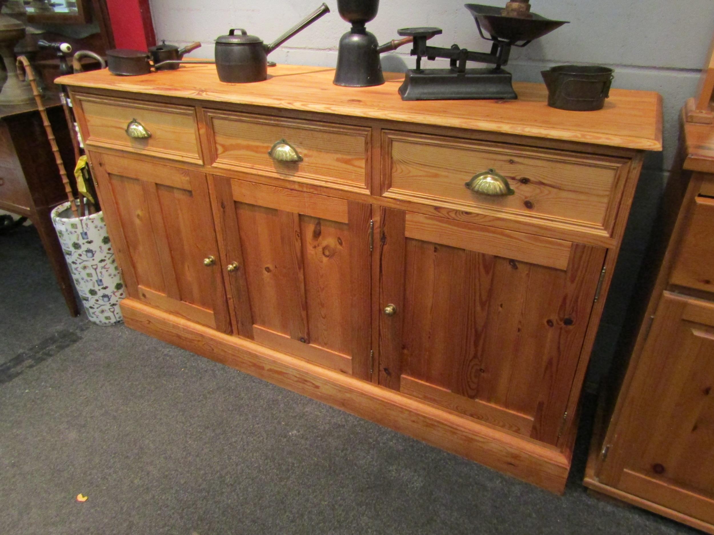 A pine dresser base with three drawers over three door cupboard, 87cm high x 152cm wide x 45cm deep