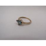 A 9ct gold ring set with blue stone, framed by four diamond chips in rub over settings, size N, 2.3g