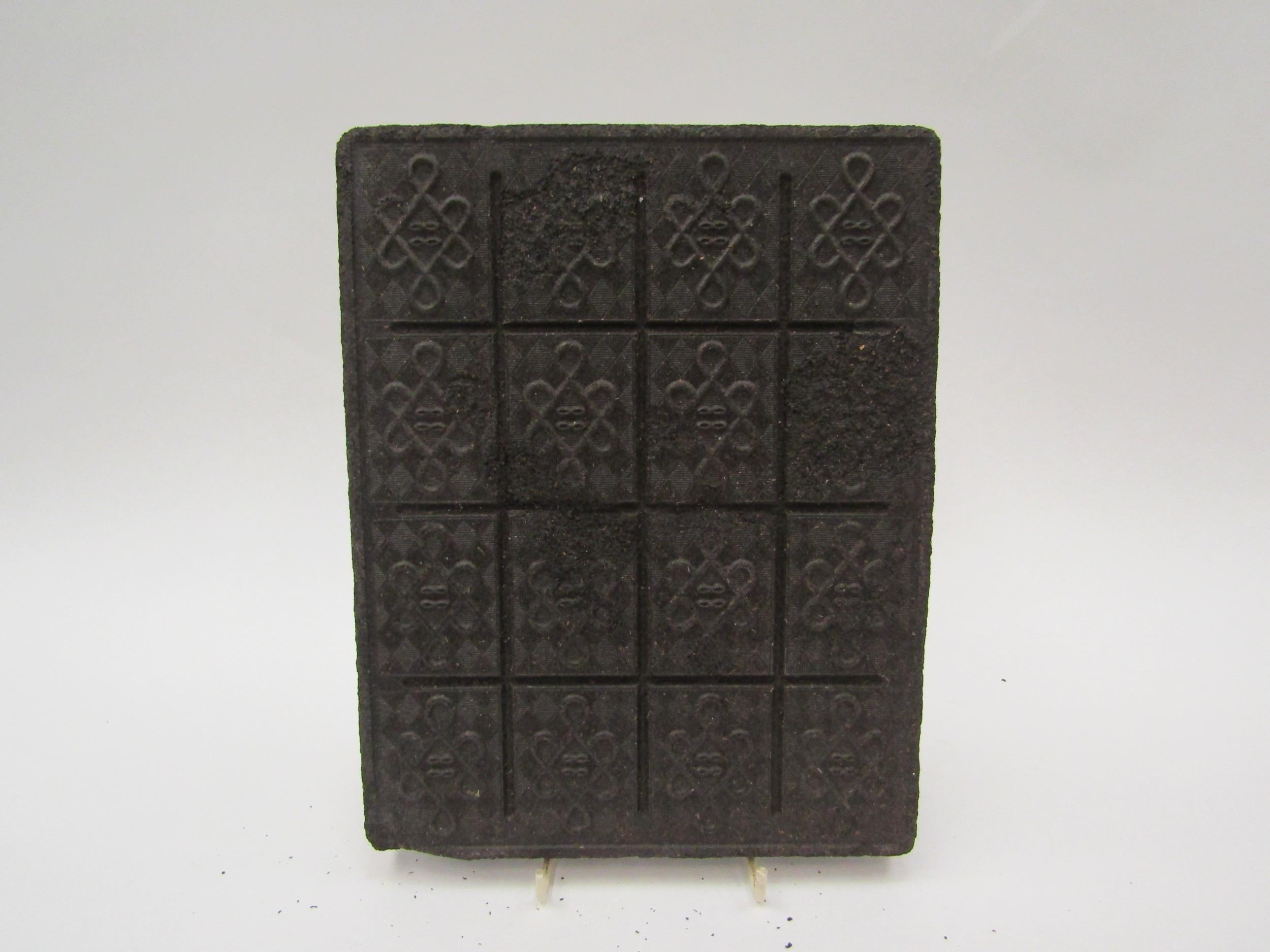 A 19th Century compressed tea brick, 19cm x 24cm