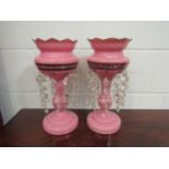 A pair of pink glass lustres, 36cm high