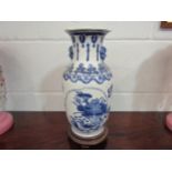 A modern Chinese blue and white vase with decoration of ducks among foliage, on wooden base, 31cm