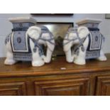 A pair of elephant form blue and white jardiniere stands, 42cm high