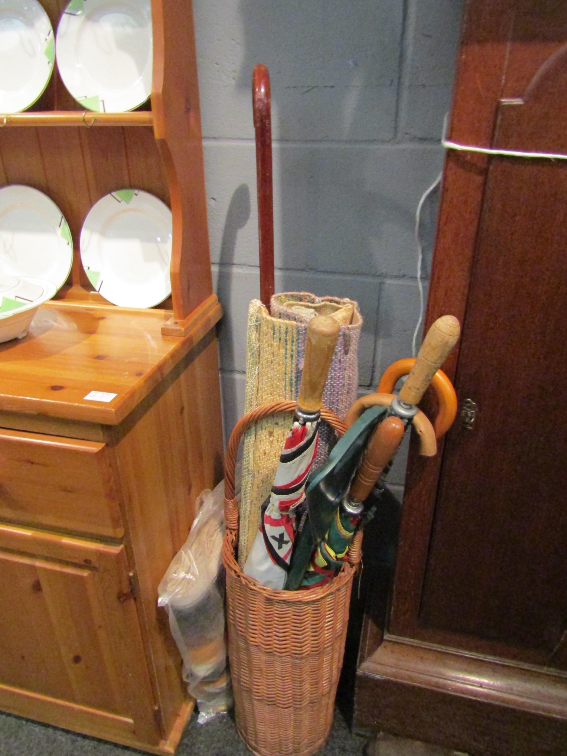A Mexican wool wall hanging together with a Spanish similar example, three golfing umbrellas,