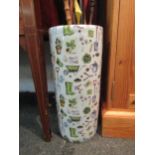 A china cylindrical umbrella and stick stand with all over design of gardening tools and plants,