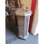 A Victorian enamelled cast iron floor standing heater with decorative floral detailing, lid with