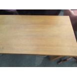 An Eastern European solid oak side table, three frieze drawers over supports joined by a