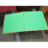 A 1940’s light oak compact card table with baize lining