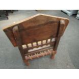 An ethnic carved hardwood tribal style folding chair