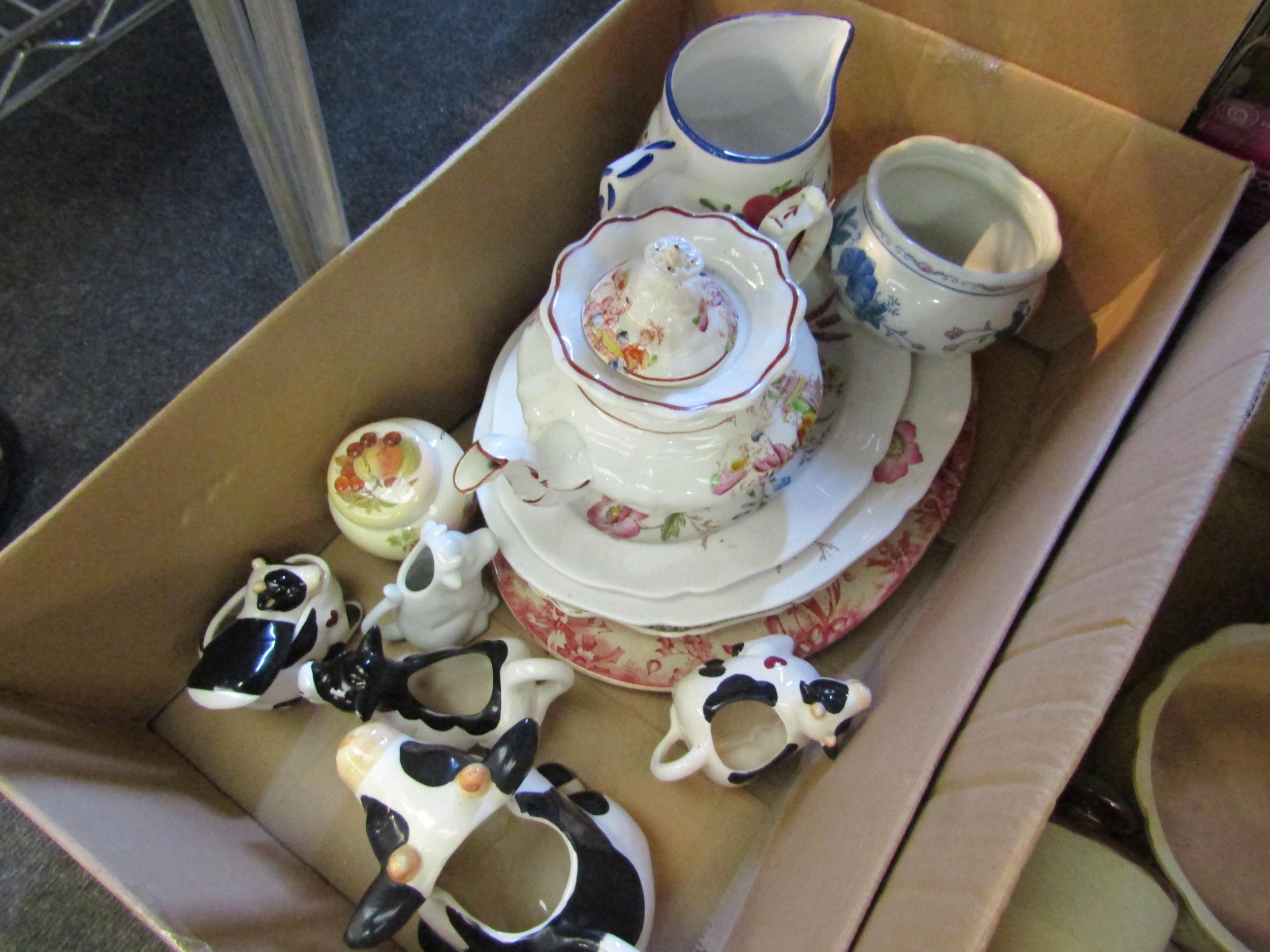 Two boxes of china and stoneware including cow milk jugs, jelly mould, teapot etc