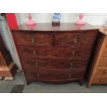 A George III flame mahogany bow front chest of two short over three graduating long drawers with oak