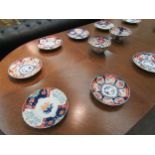 Ten Japanese Imari plates and two bowls, one with character marks to base and some a/f