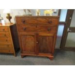 An early Victorian mahogany cabinet, the two drawers over two cupboard doors, bracket supports, some