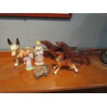 A quantity of ceramic figures including dogs, a Wade fish design pin dish and figures. Some a/f (7)