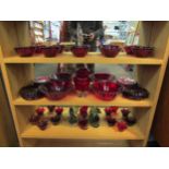A collection of Cranberry glass including bowls, dishes, vase and candle holders with three duck