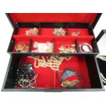 A jewellery box with bijouterie contents, necklaces, brooches and earrings