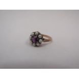 A rose gold pearl and amethyst dress ring, central amethyst surrounded by eight pearls. Stamped 9ct,
