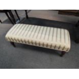 A Victorian style long footstool with Regency stripe upholstery, 36cm high x 106cm long