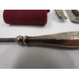 A white nurses belt and two silver handled button hooks etc