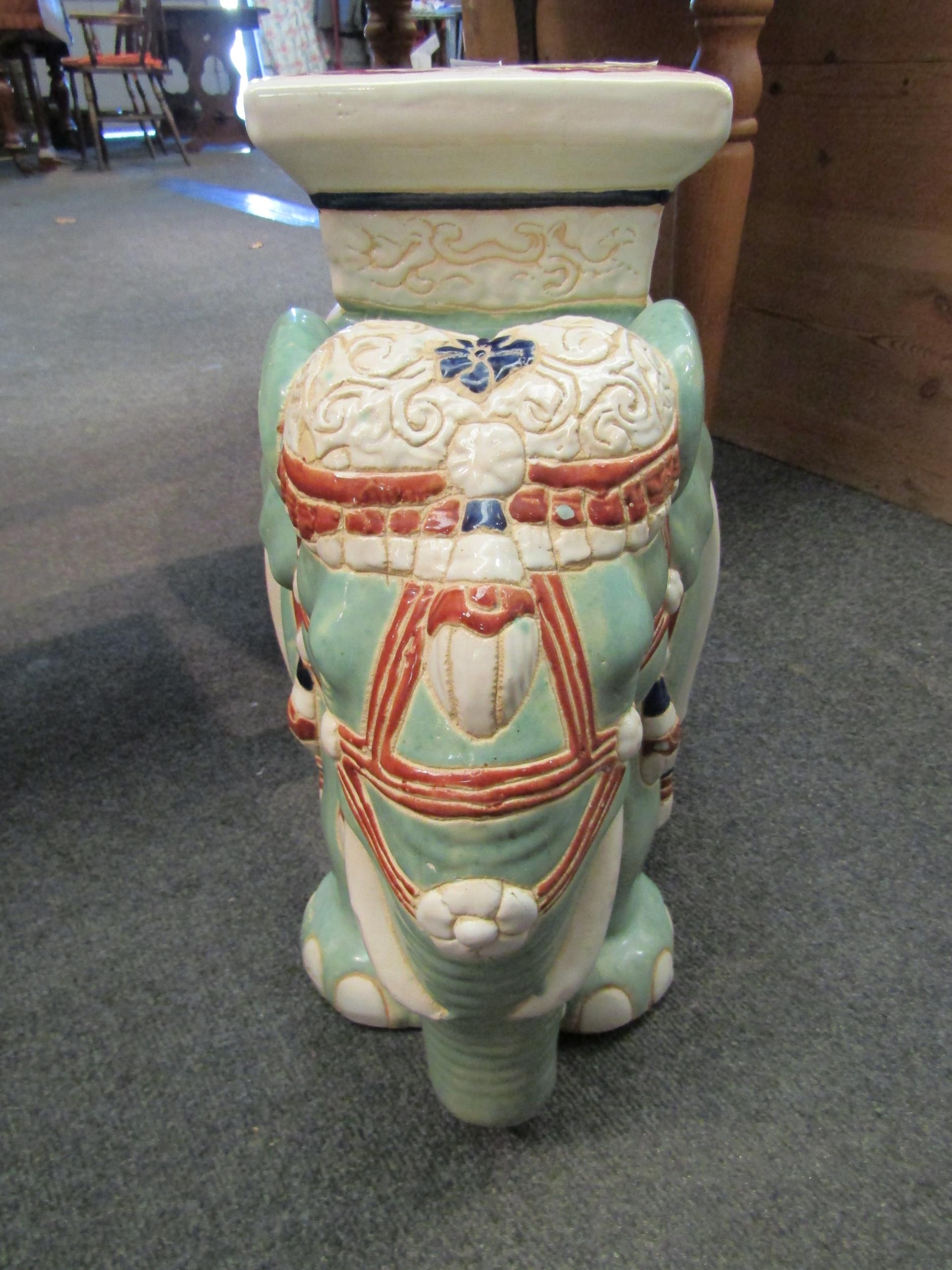 A modern Chinese style glazed pottery jardiniere stand in the form of an elephant, 45cm high