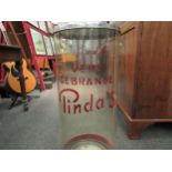 A 1950's retro peanut dispenser, the chrome top over a plastic cylinder with "Vers Gebrande Pinda's'