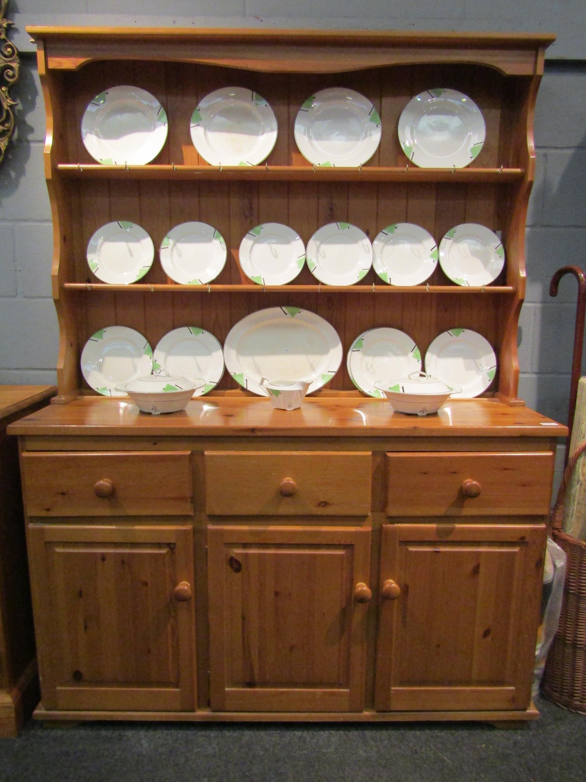A modern pine dresser, the plate rack top over three drawers and three cupboards, 183cm high x 136cm