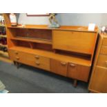 A retro 1960’s teak sideboard with glazed display section, drop-flap, four drawers and two