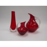 Two Whitefriars ruby red glass jugs and a Whitefriars cased red glass vase. Tallest 20.5cm