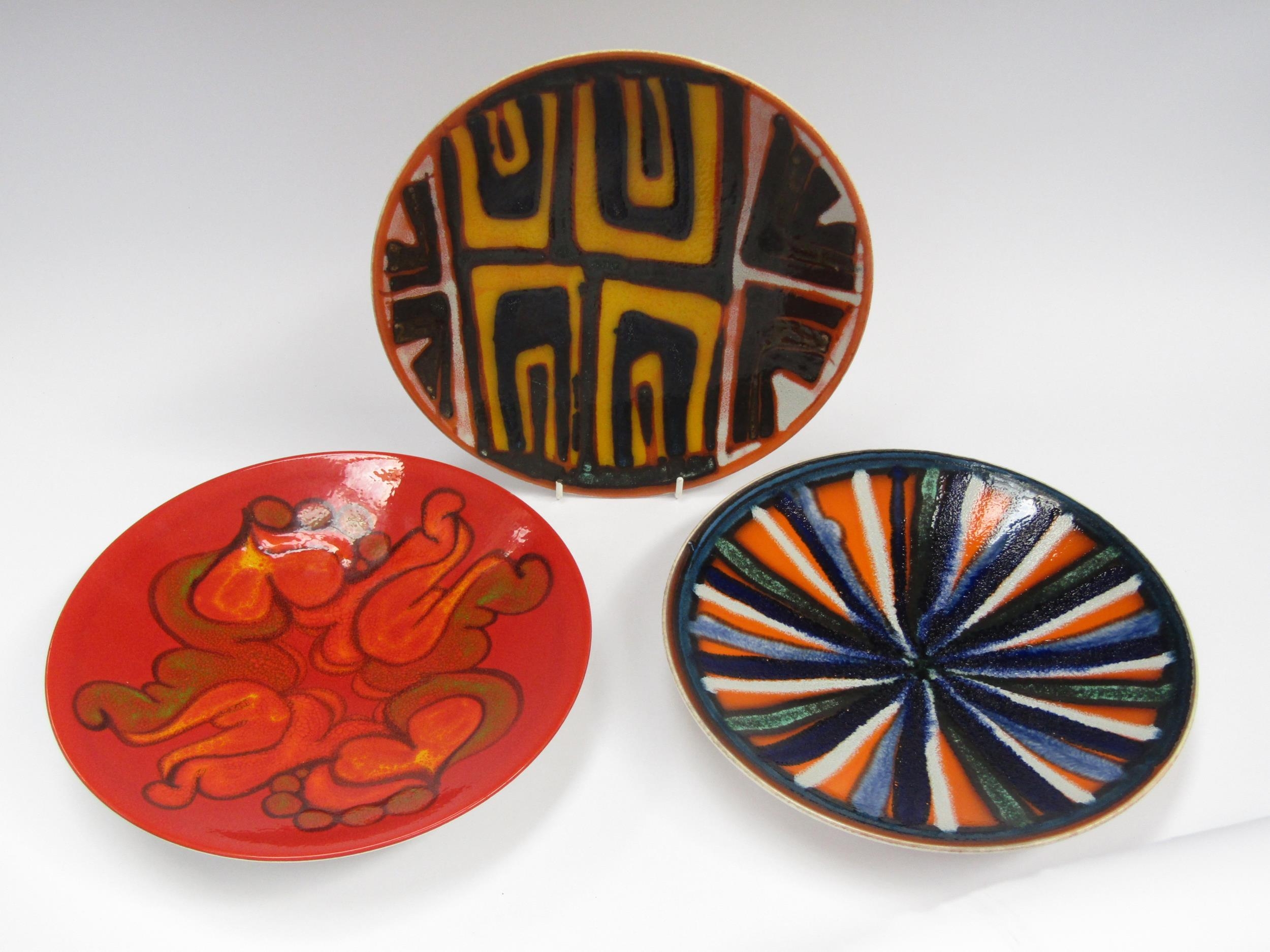 Three Poole Pottery Delphis plates, various designs, black backstamps. 27cm diameter