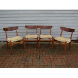 A set of four Hans Wegner CH23 dining chairs for Carl Hansen with corded seats, bar back with