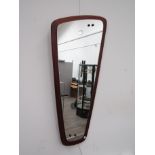 A vintage 1960's mirror of abstract form on teak backing, 73cm x 35cm