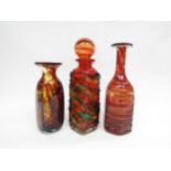 Three pieces of Mdina glass consisting of two vases and decanter, red tones. Tallest 29cm