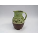 A Winchcombe Pottery large jug, green glazed upper section with slip detail. Impressed mark to base,