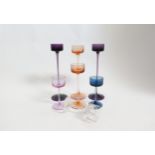 Seven Wedgwood 'Brancaster' glass candlestick in amethyst, topaz, pink and clear. Tallest 29cm