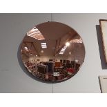A Mid 20th Century circular convex form wall mirror with copper colour finish. 45cm diameter