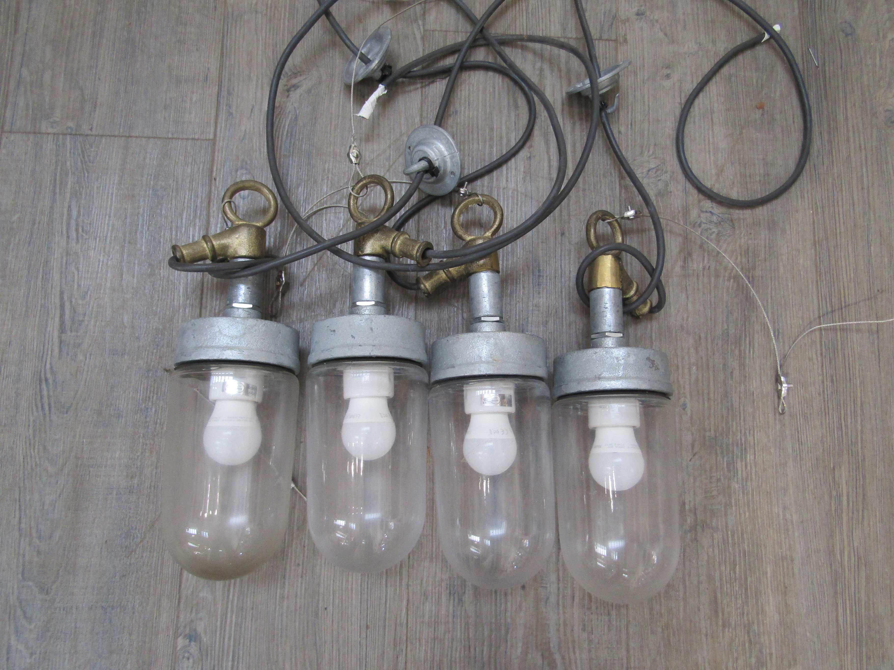 Four industrial exterior style ceiling pendants in painted grey metal and heavy duty glass
