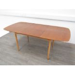 An extending dining table, mid 20th Century with fold away leaves. (There are repairs to two leg