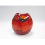 A modern Poole Pottery "Volcano" vase in reds, orange and blue glazes, purse form, 18.5cm high