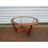 A G-Plan circular Astro table in teak and clear glass. 84cm diameter x 46cm high