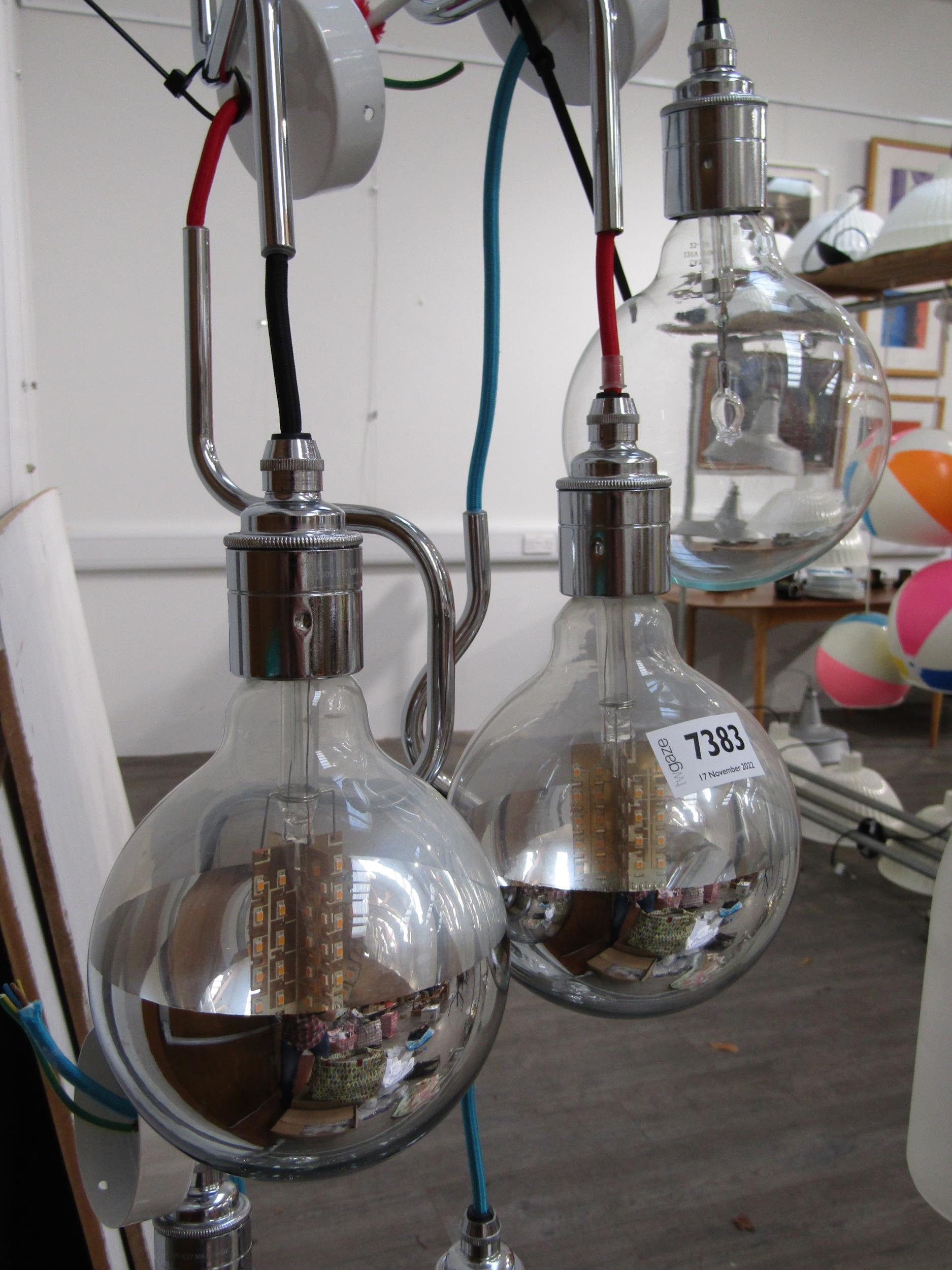 A set of six globe lights with three half chromed shades, three clear and chromed fittings
