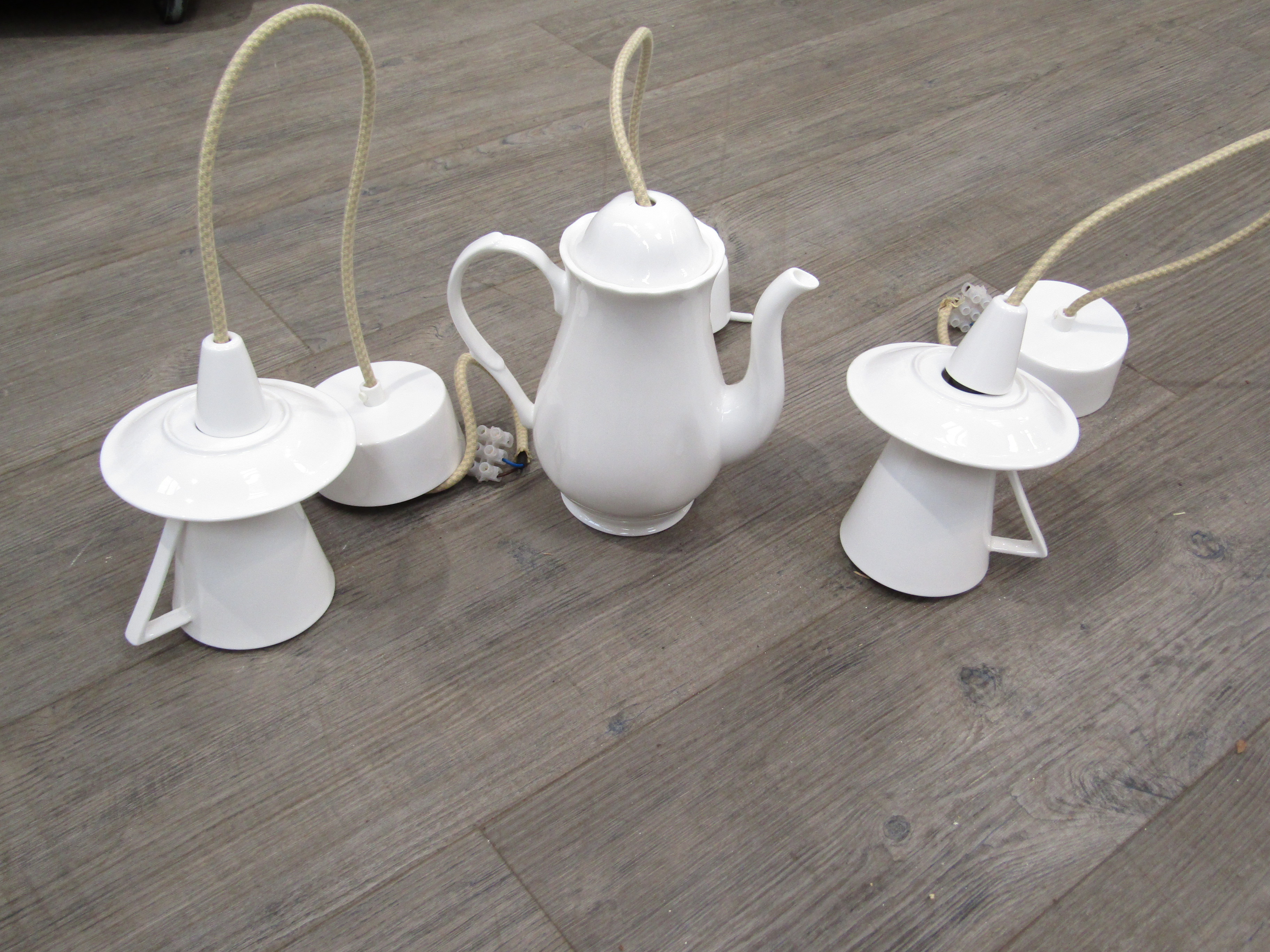 A novelty porcelain ceiling light in the form of a coffee pot in white glaze, together with a pair