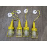 Four ceiling pendant lights in the form of yellow inspection lights. Each 28cm high