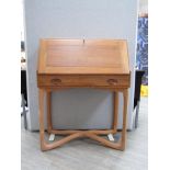 An Ercol light elm model 518 bureau on "X" base, fitted interior to fall flap front, 81cm wide x