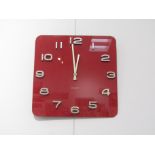 A Karlsson red glass battery wall clock. 35cm x 35cm