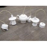 A novelty porcelain ceiling light in the form of a teapot in white glaze, together with a pair of