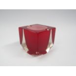 An Italian glass ashtray in red and white encased in clear, textured bottom corners. 9cm high