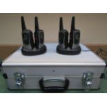 A set of four Uniden walkie talkies and chargers in associated metal carry case