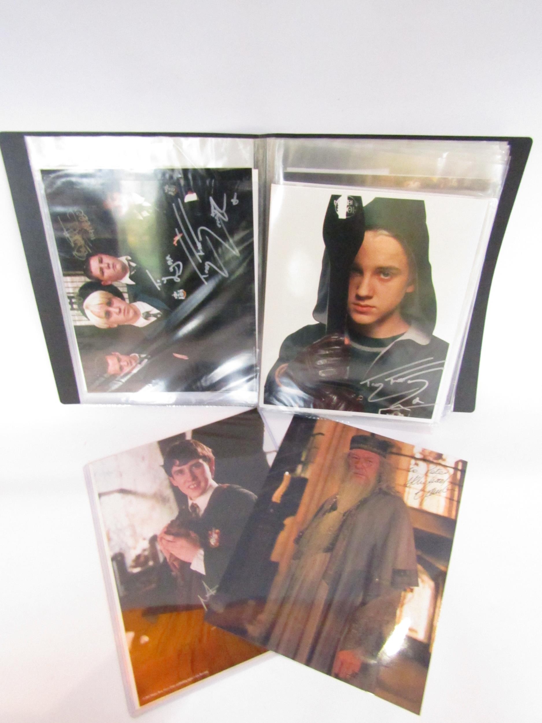 HARRY POTTER INTEREST: An album of publicity photographs from the Harry Potter film series signed by