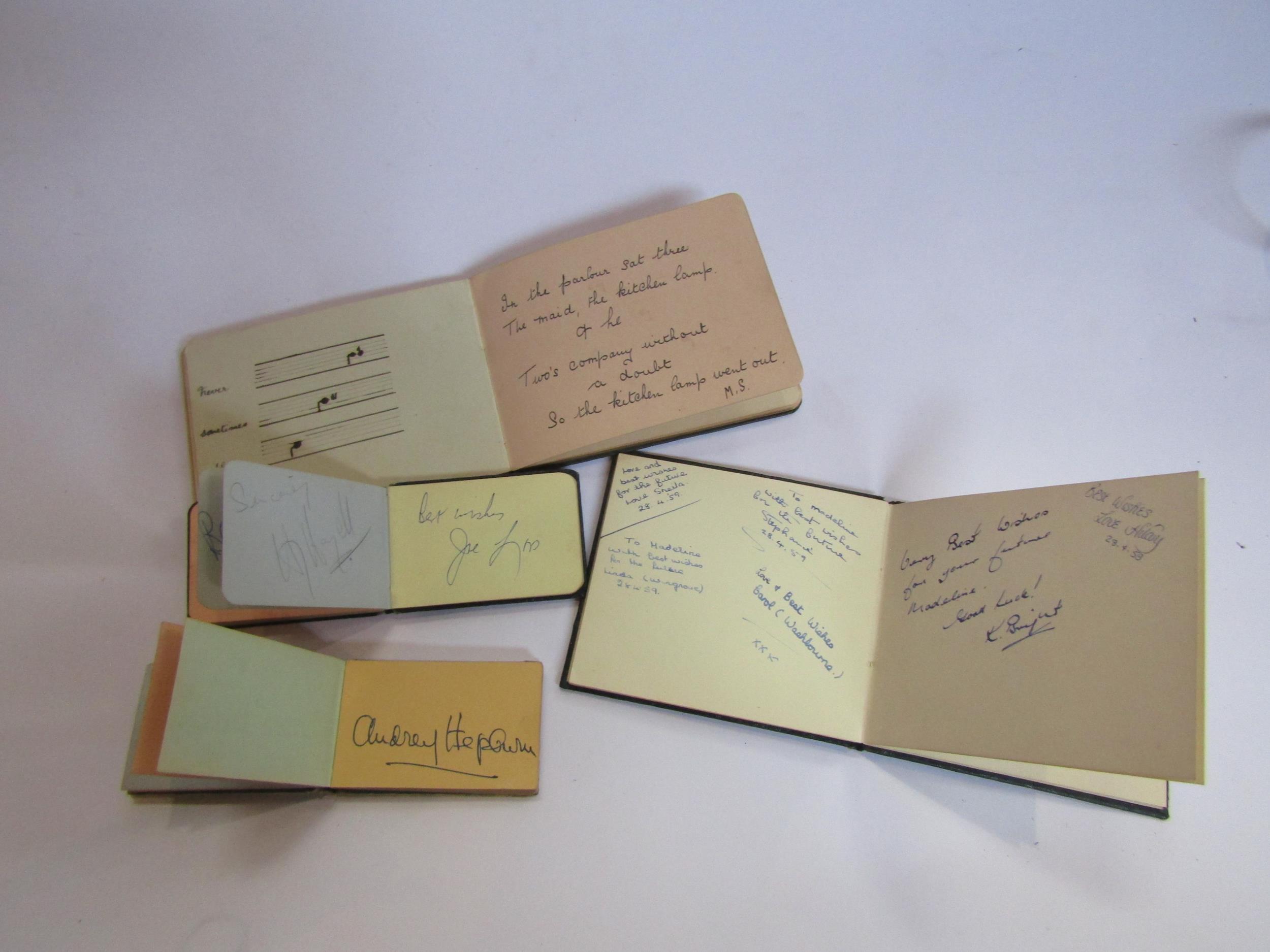 Four 1950's autograph books containg various signatures including Audrey Hepburn